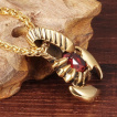 Pendentif acier dor scorpion  pierre rouge