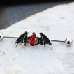Piercing industriel à ailes de démon strass rouges rubis