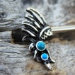 Piercing tton  ailes d'oiseau noircies  bulles bleues